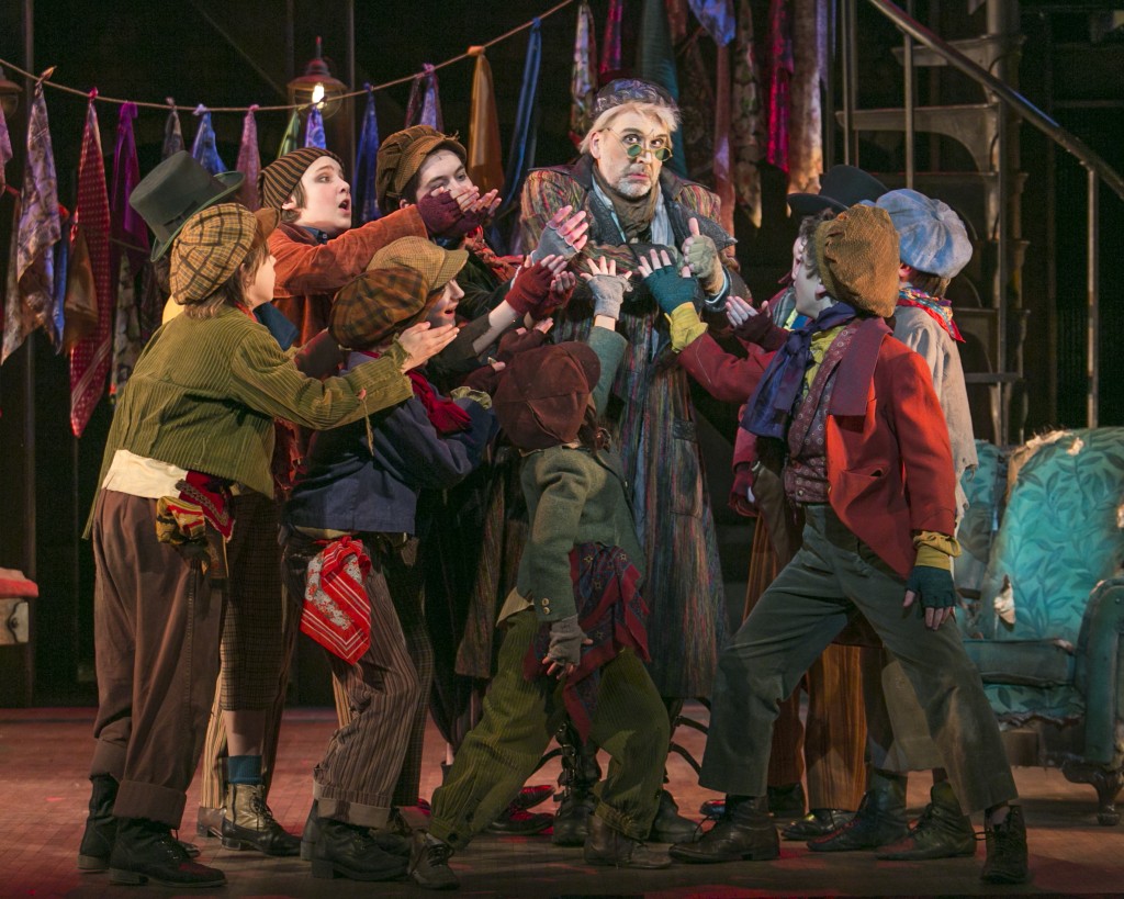 Bradley Greenwald as Fagin (center) and the cast of Oliver. Photo by Heidi Bohnenkamp.